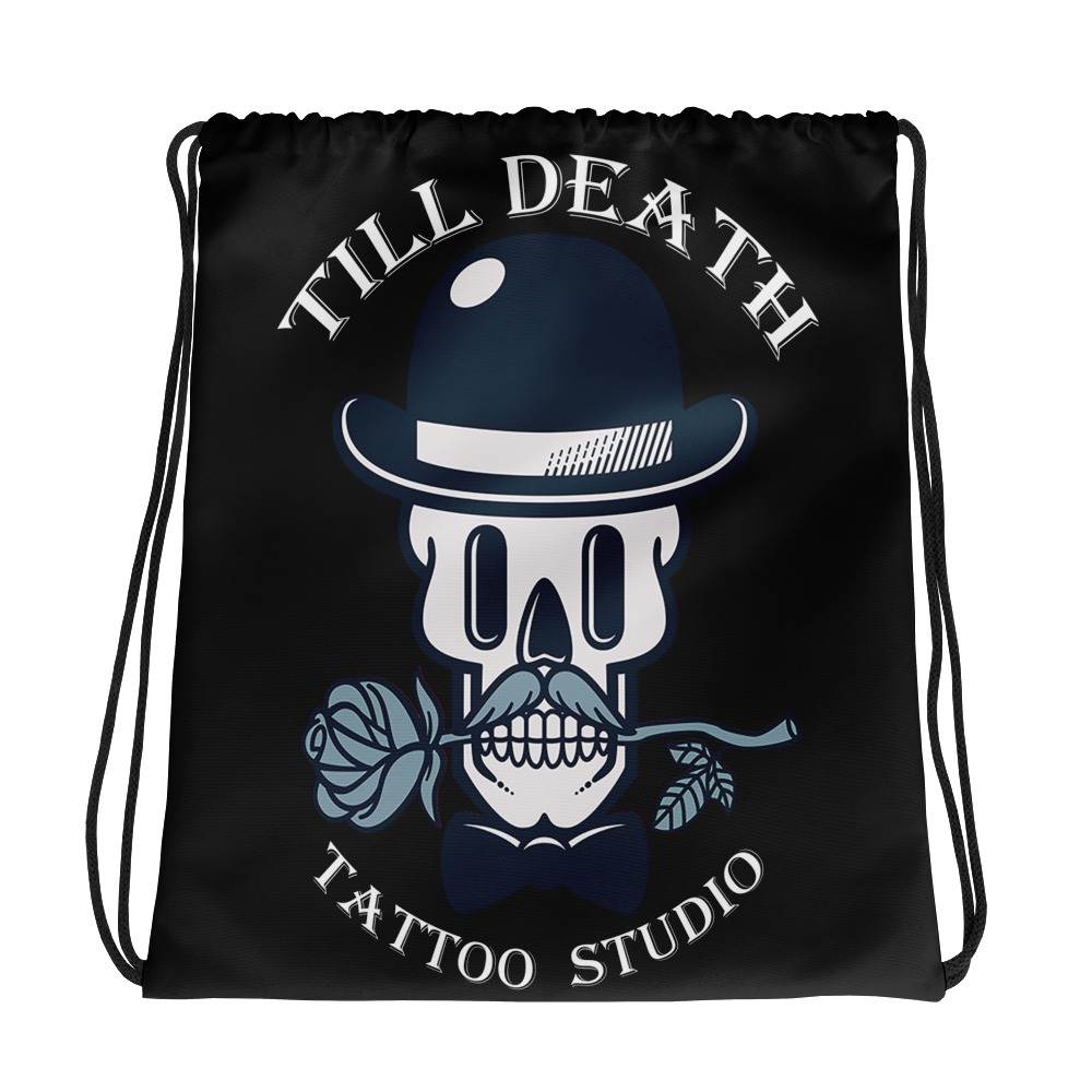 The all-over-print drawstring bag showcases a skull adorned in a bowler hat, gripping a rose between its teeth. Featuring bold text that reads "Till Death Tattoo Studio," it's the ideal accessory for those with an edgy style.